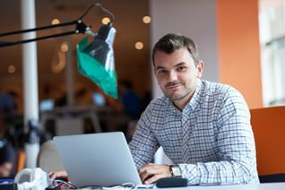 employee sitting and smiling