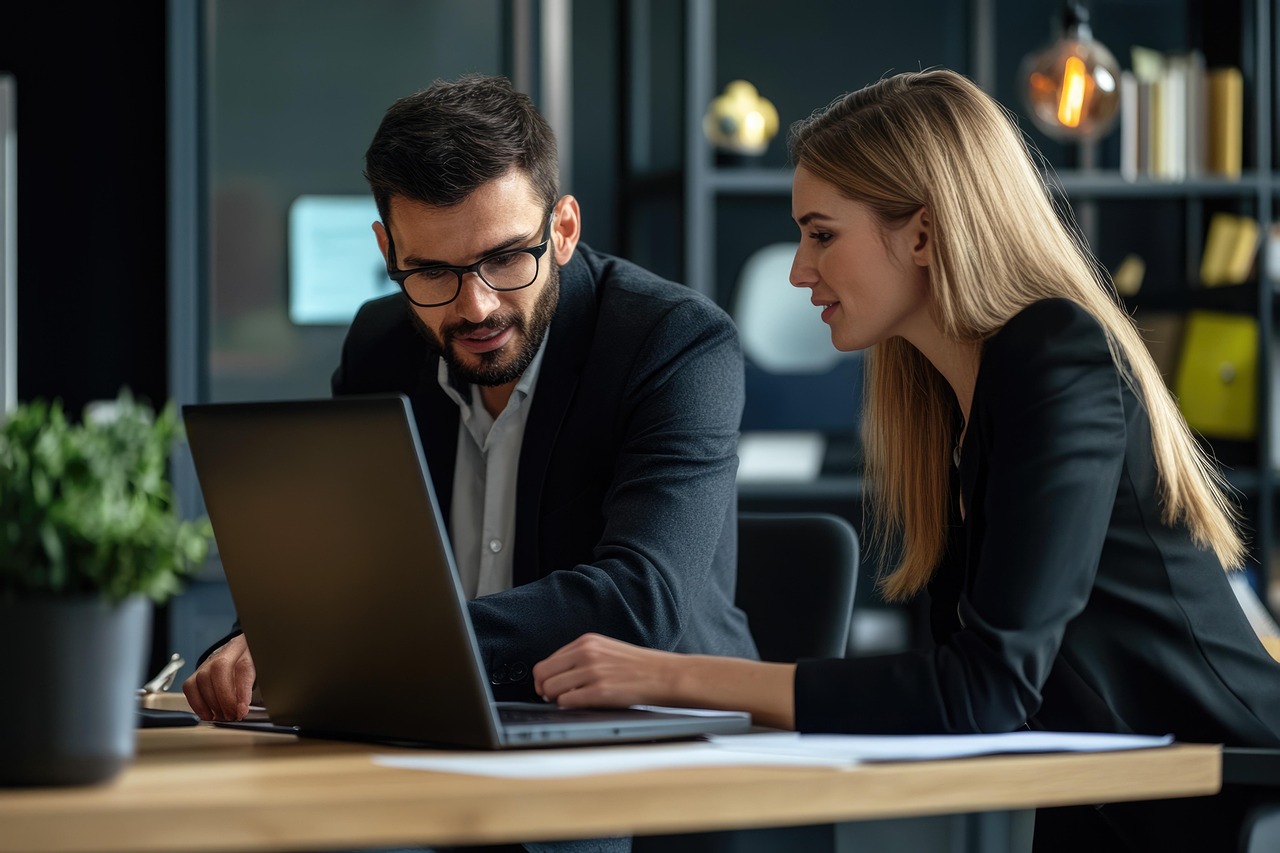 Two people looking at a laptop