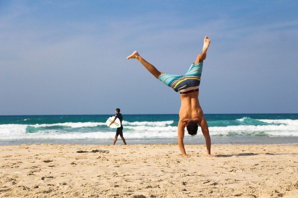 Man cartwheeling on the beach